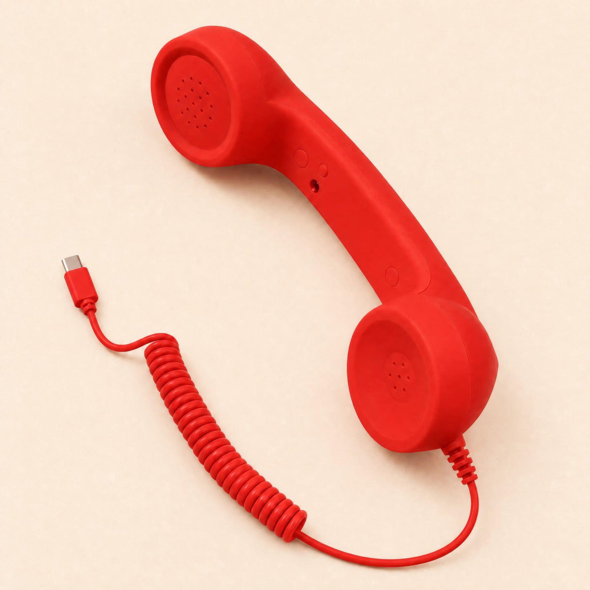 Red retro telephone handset with coiled USB-C cable